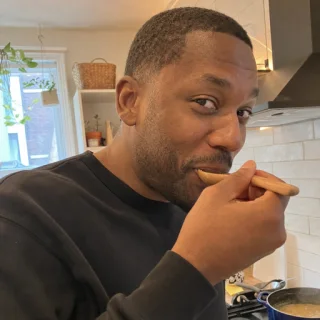 Jordan tasting food in his home kitchen